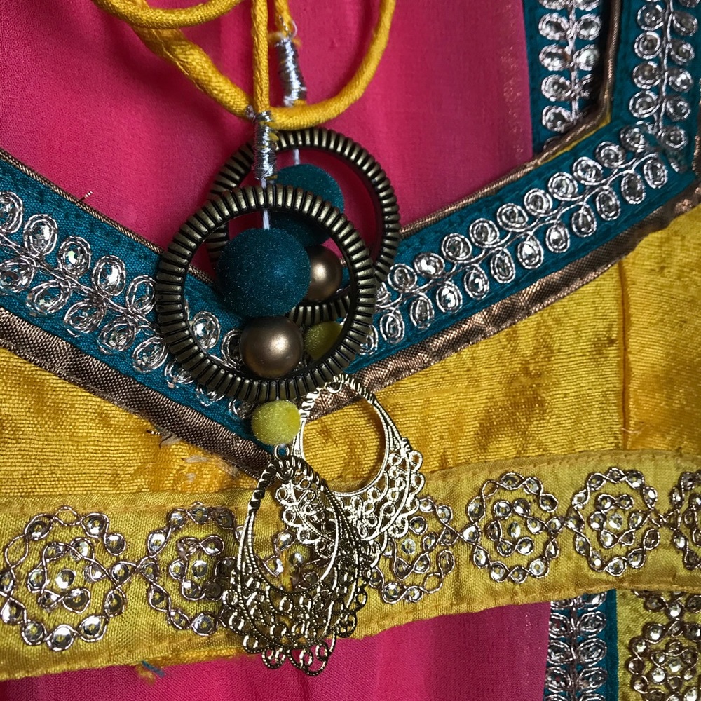 Pink Saree with yellow top & turquoise details.
